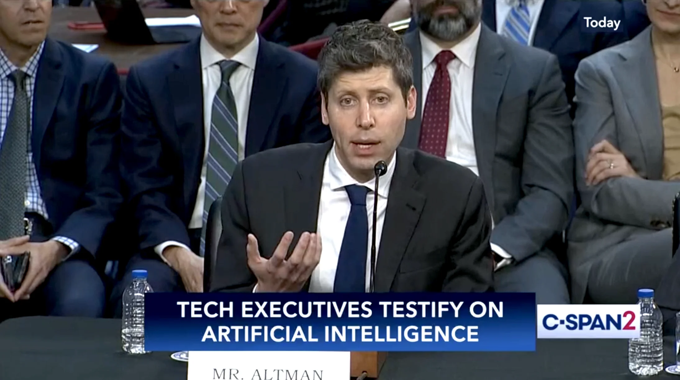 Sam Altman, OpenAI CEO, testifying again to the US Senate in May 2025. C-SPAN2 chyron reads 'Tech Executives Testify on Artificial Intelligence.' Editorial quote: 'I am nervous about standards being set too early.'