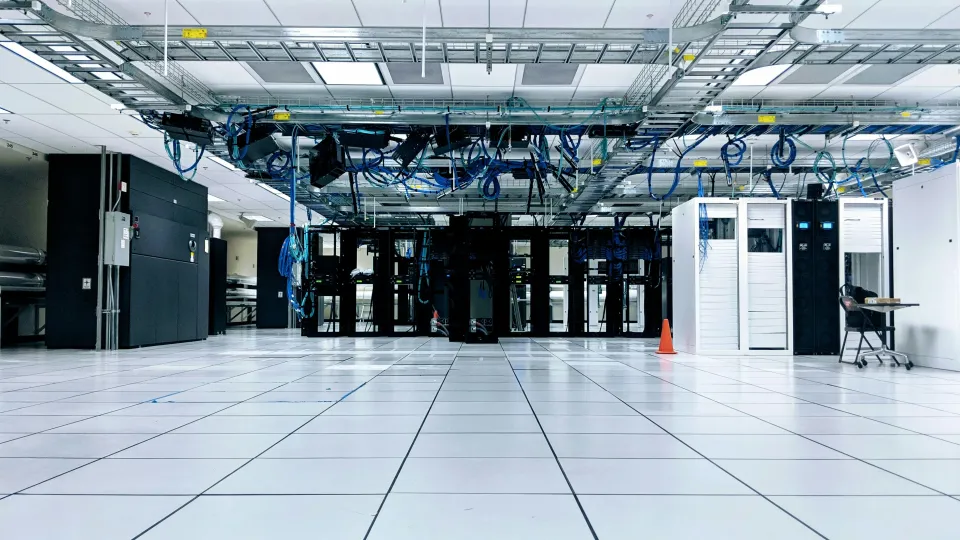 Rows of servers in a data center – AI's growing physical footprint