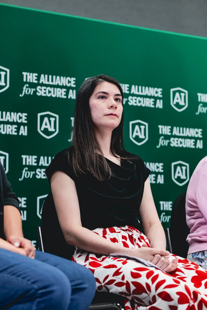 Vael Gates, founder of Humans in Control, seated on a conference panel in front of an Alliance for Secure AI backdrop.